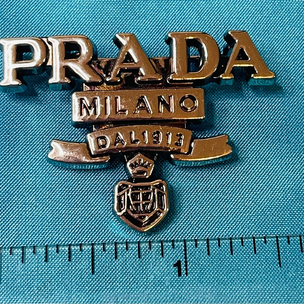 Prada Brooch Silver Logo Emblem Pin NIB
